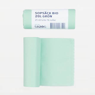 gröna avfallspåsar på grå bakgrund